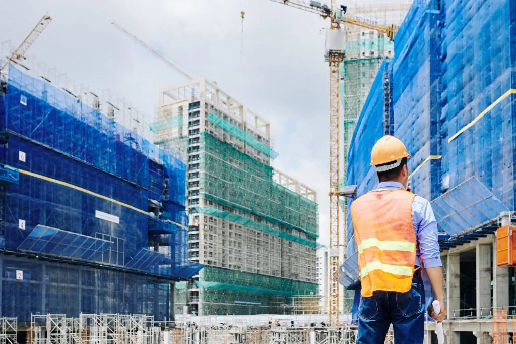 Professional engineer looking at building under construction